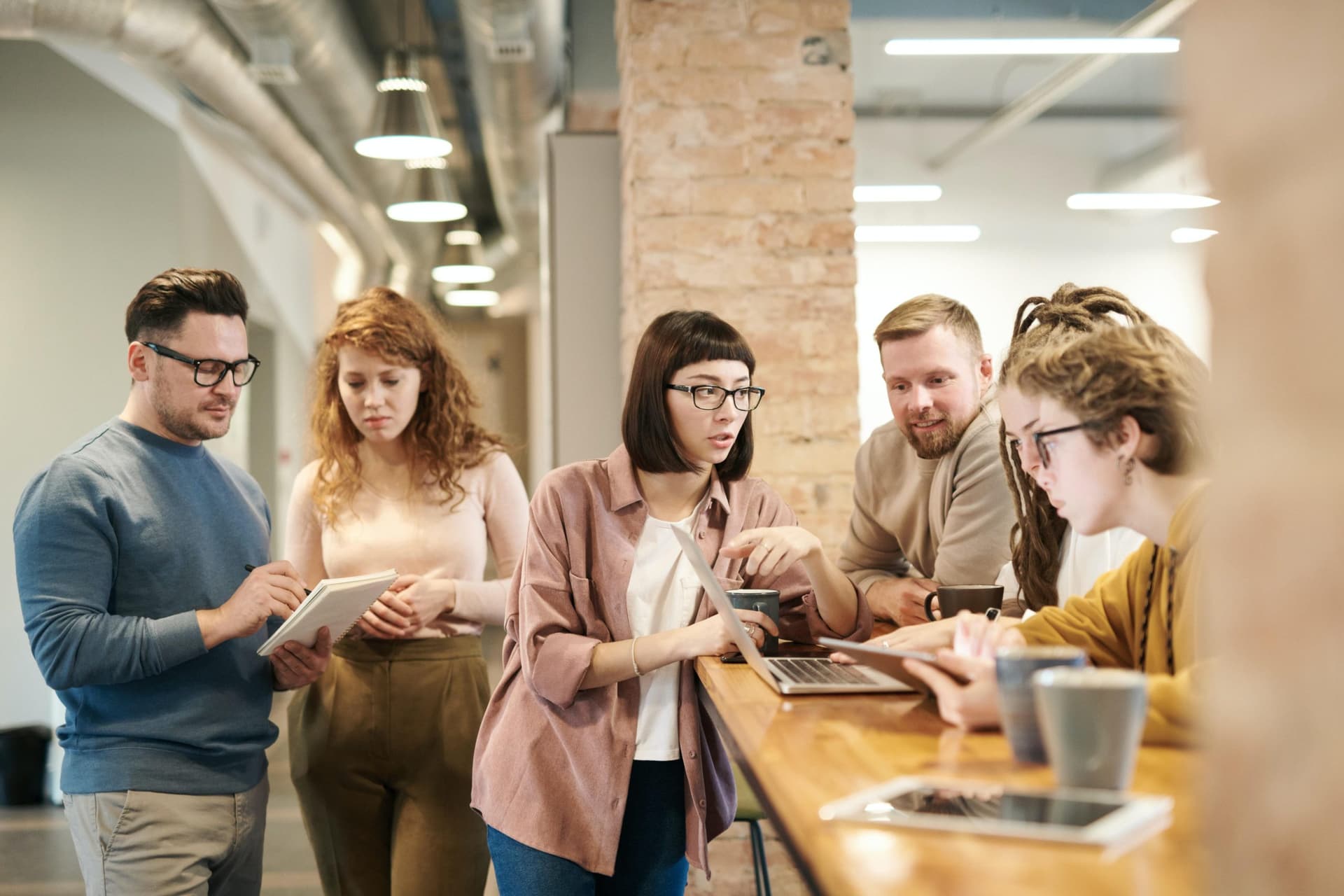 A group of co-workers prepares for one of their daily stand-up meetings.