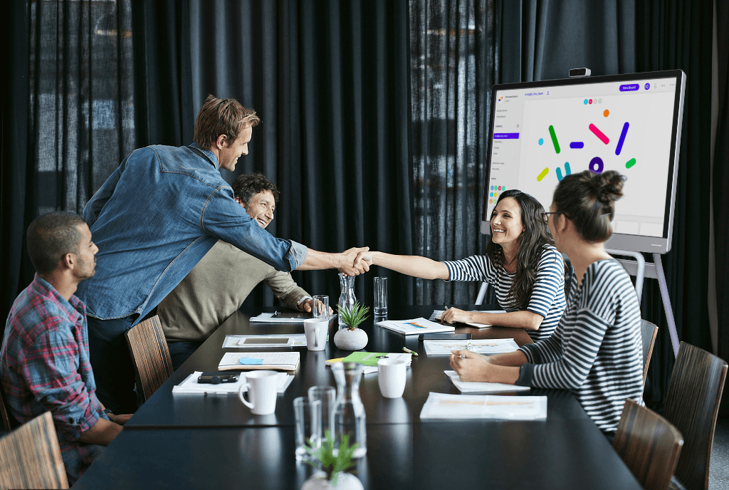 An office team wraps up a whiteboarding meeting.