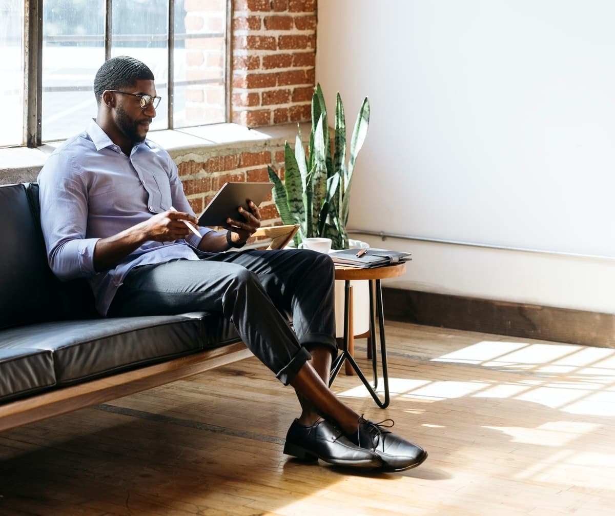 A small side table and a comfy couch can easily function as a dedicated work space.
