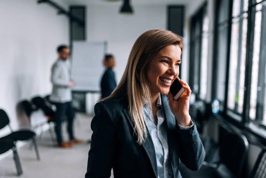 A woman is answering a call in a conference room