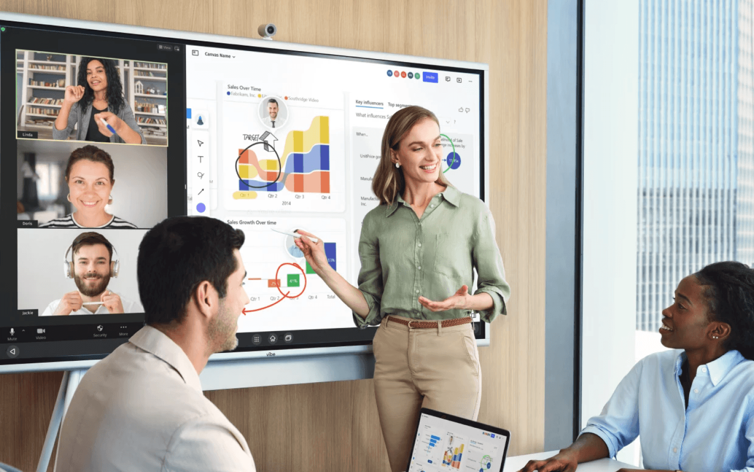 Diverse team aligning project ideas during hybrid in-person and virtual collaboration session.